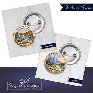 May include: Two circular pin-back buttons featuring landscape illustrations. One button displays a Wisconsin scene with a waterfall and text reading 2026 INTERNATIONAL CONVENTION from WISCONSIN WITH ALL OUR LOVE. The other shows a Wyoming mountain landscape with a bison and text reading 2026 INTERNATIONAL CONVENTION from WYOMING WITH ALL OUR LOVE.
