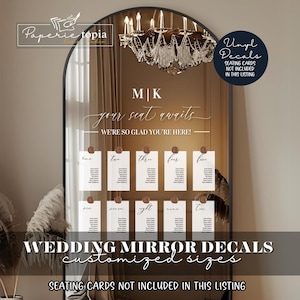 May include: A wedding mirror decal set with the text "your seat awaits" and "WE'RE SO GLAD YOU'RE HERE!" in a gold script font. The decals are displayed on a mirror with a decorative chandelier above. The text "Vinyl Decals" is in a white box with a black outline. The text "SEATING CARDS NOT INCLUDED IN THIS LISTING" is in a white box with a black outline.
