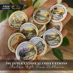 May include: A collection of round pin-back buttons featuring colorful landscape illustrations and text reading 2026 International Convention from various U.S. states including California, Florida, South Carolina, Texas, Virginia, New York, and Wyoming.