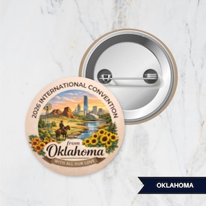 May include: A round pinback button featuring a colorful illustration of a cowboy on horseback, sunflowers, and a city skyline. The text reads 2026 INTERNATIONAL CONVENTION from Oklahoma WITH ALL OUR LOVE. The back shows a metal pin mechanism.
