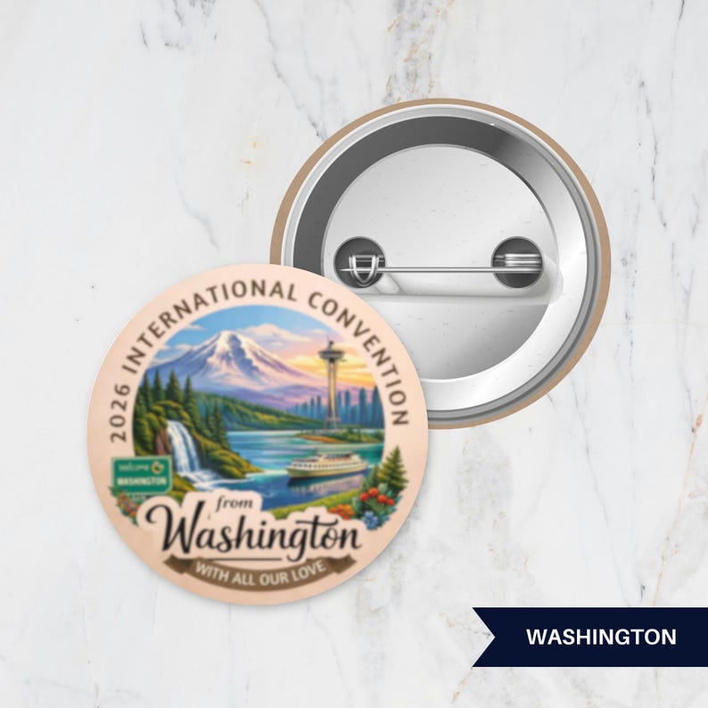 May include: A round pinback button featuring a colorful illustration of a mountain, a waterfall, a tower, and a boat. The text reads 2026 INTERNATIONAL CONVENTION from Washington WITH ALL OUR LOVE. The back shows a metal pin mechanism.