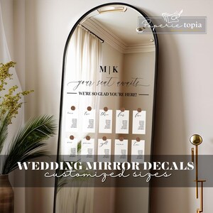 May include: A wedding mirror decal set with the text "MK your seat awaits WE'RE SO GLAD YOU'RE HERE!" and a grid of seating cards numbered one to ten.