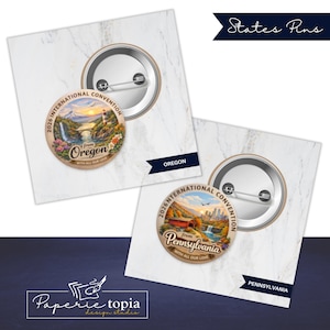 May include: Two round pin-back buttons featuring colorful landscape illustrations. One button displays a lighthouse, waterfall, and the text 2026 INTERNATIONAL CONVENTION from Oregon WITH ALL OUR LOVE. The other shows a covered bridge and Pennsylvania.