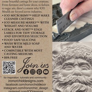 May include: A product package from Iron Orchid Designs, featuring a Santa Claus face mold. The package includes text about the product's features, such as measure marks and food-safe silicone. A ruler shows a measurement of 0 inches.