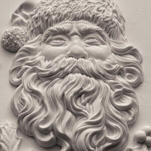 May include: A detailed, off-white relief sculpture of Santa Claus's face. The sculpture features a fluffy hat, a full beard, and a smiling expression. Holly leaves and berries are visible at the bottom. The artwork is a festive, three-dimensional representation of the holiday figure.