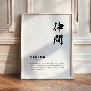 Puede incluir: Una impresión enmarcada en blanco con texto negro que dice "Nakama - Japonés" y define la palabra como "Más que solo amistad, es un vínculo formado a través de objetivos compartidos, lealtad y apoyo mutuo - una conexión que define lo que significa caminar juntos por la vida."