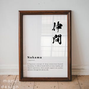 May include: A framed wall art print featuring the Japanese kanji for Nakama in black ink. Below the characters, the word Nakama is printed in bold, followed by the definition of the Japanese concept of deep connection and friendship.
