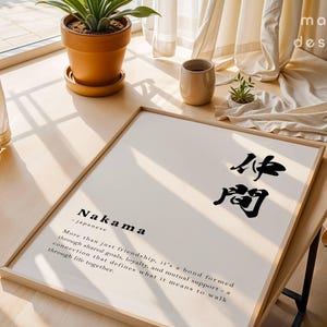 May include: A framed wall art print featuring the Japanese word Nakama in black calligraphy, followed by the English definition: More than just friendship, it's a bond formed through shared goals, loyalty, and mutual support.