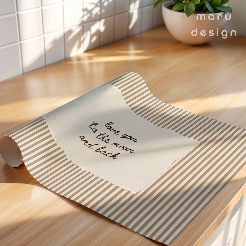 May include: A roll of paper with a tan and white striped pattern. The paper has a torn edge with the handwritten text "love you to the moon and back". The maru design logo is in the upper right corner.
