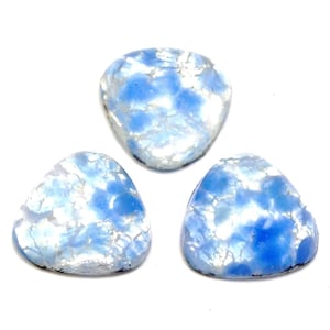 May include: Three blue and white triangular cabochons with a marbled pattern.