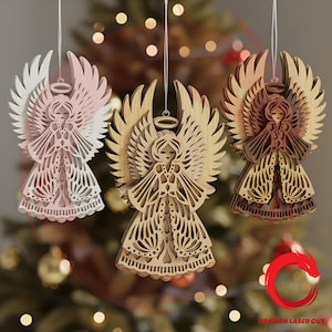 May include: Three wooden angel ornaments with intricate cut-out designs. The angels are in shades of pink, natural wood, and dark brown, each with detailed wings and halos. They are suspended by strings, perfect for holiday decorations.