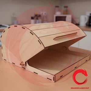 May include: A wooden bread box with a curved top and a hinged lid. The box is made of light-colored wood and has a rectangular base. The lid features a small handle for easy opening. The box is designed with interlocking joints and a smooth finish.