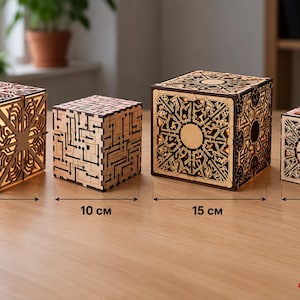 May include: Four wooden cube lamps with intricate laser-cut patterns. The cubes measure 13 cm, 10 cm, 15 cm, and 10 cm respectively. The designs feature geometric and circuit-like motifs, with internal lighting visible through the cutouts.