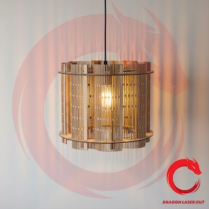 May include: A cylindrical wooden pendant light fixture with vertical slats, suspended from a black cord. The light fixture has a warm, natural wood tone and a bright light bulb is visible inside. The bottom edge has a decorative, wavy design. The logo "DRAGON LASER CUT" is visible.