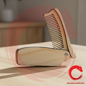 May include: A wooden folding comb with a natural finish. The comb is made of thin, laser-cut wood pieces and features a hinge for folding. The comb's teeth are visible, and the design includes a curved handle. The comb is on a light-colored surface.