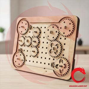 May include: A rectangular wooden gear board featuring a grid of square holes and multiple interlocking gears of varying sizes. The light-colored wood construction includes several circular gears with teeth and decorative cutouts, all mounted on a flat base.