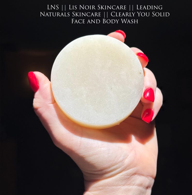 Organic cream colored  face and body wash soap bar for acne in hand.