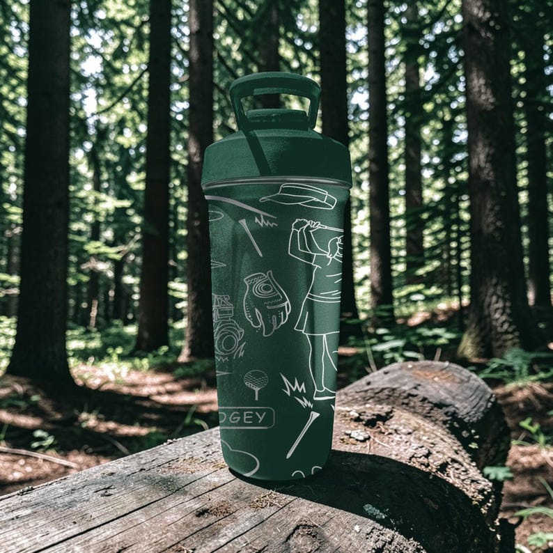 May include: A dark green water bottle with a handle and golf-themed illustrations in white. The bottle features images of a golfer, golf clubs, and other golf-related items. The word "DOGEY" is printed on the bottle.