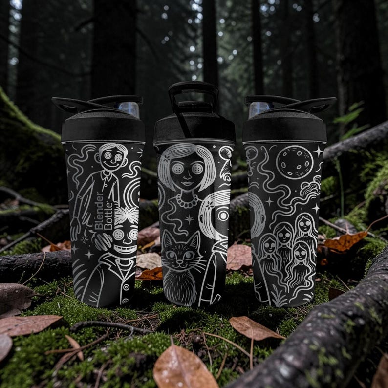 May include: Three black Blender Bottles with white illustrations of characters and designs. One bottle features a character with buttons for eyes, another a girl with a cat, and the third a moon and figures. The bottles are set in a forest.