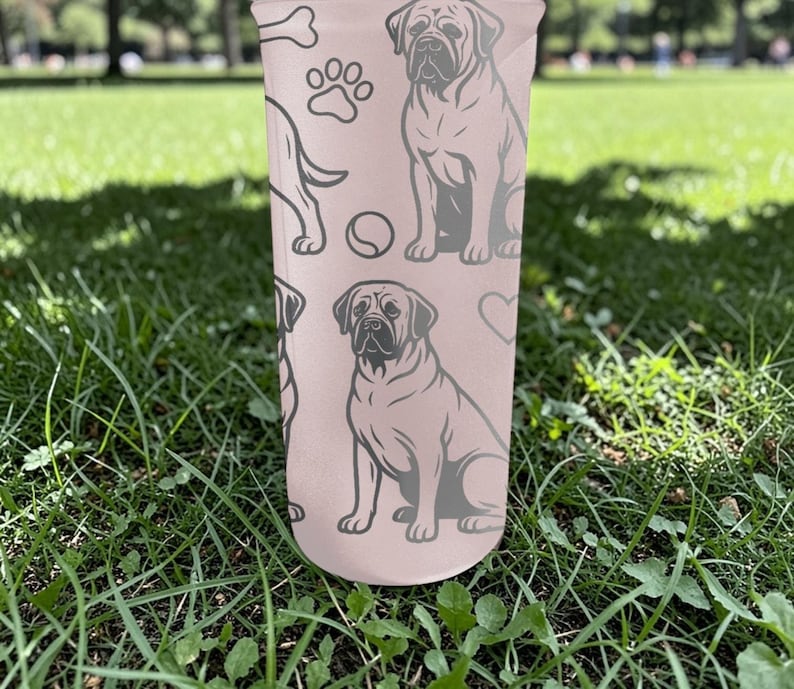 May include: A light pink tumbler featuring a repeating pattern of dog illustrations, paw prints, bones, and hearts. The dogs are depicted in a seated position. The tumbler is cylindrical and appears to be made of a durable material.