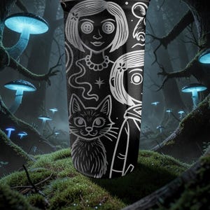 May include: Black tumbler featuring a detailed white illustration of a girl with button eyes, a cat, and other whimsical elements. The design is set against a dark background, evoking a mysterious and fantastical theme. The tumbler is cylindrical and appears to be made of a durable material.
