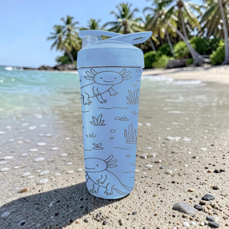 May include: A light blue water bottle featuring a cartoon axolotl design. The bottle has a flip-top lid and is decorated with axolotls, aquatic plants, and bubbles. The bottle is shown on a sandy beach with palm trees in the background.