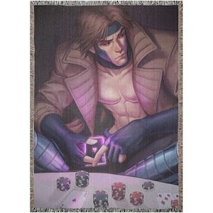 May include: A woven tapestry throw blanket featuring a comic book character with purple and blue accents. The character is sitting at a table with playing cards and chips.