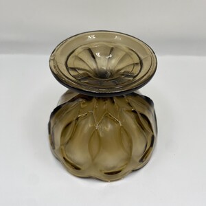 May include: An amber-coloured vintage glass dessert dish. The bowl has a textured, patterned design with a scalloped edge. The stem is short and the base is round. The glass has a slight iridescence.