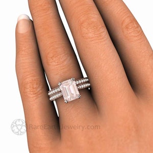 May include: A rose gold engagement ring with a large, rectangular, light pink gemstone surrounded by smaller diamonds. The ring is set with a matching band with smaller diamonds.