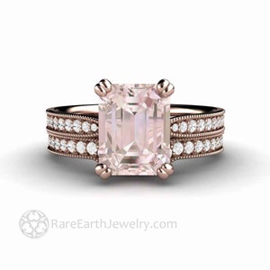 May include: A rose gold engagement ring with a large, square-shaped, pale pink gemstone set in a prong setting. The ring has a matching band with a row of small diamonds on each side.