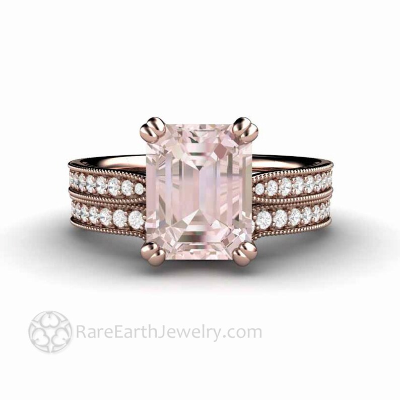 May include: A rose gold engagement ring with a large, square-shaped, pale pink gemstone set in a prong setting. The ring has a matching band with a row of small diamonds on each side.
