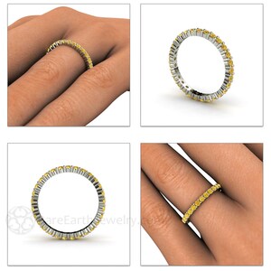 May include: A yellow sapphire eternity band ring with a polished silver setting. The ring is shown on a model's finger.