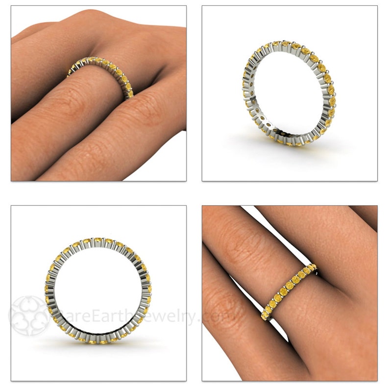 May include: A yellow sapphire eternity band ring with a polished silver setting. The ring is shown on a model's finger.