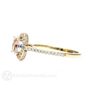 May include: A gold engagement ring with a large oval-shaped center stone surrounded by a halo of smaller diamonds. The band is also set with smaller diamonds.