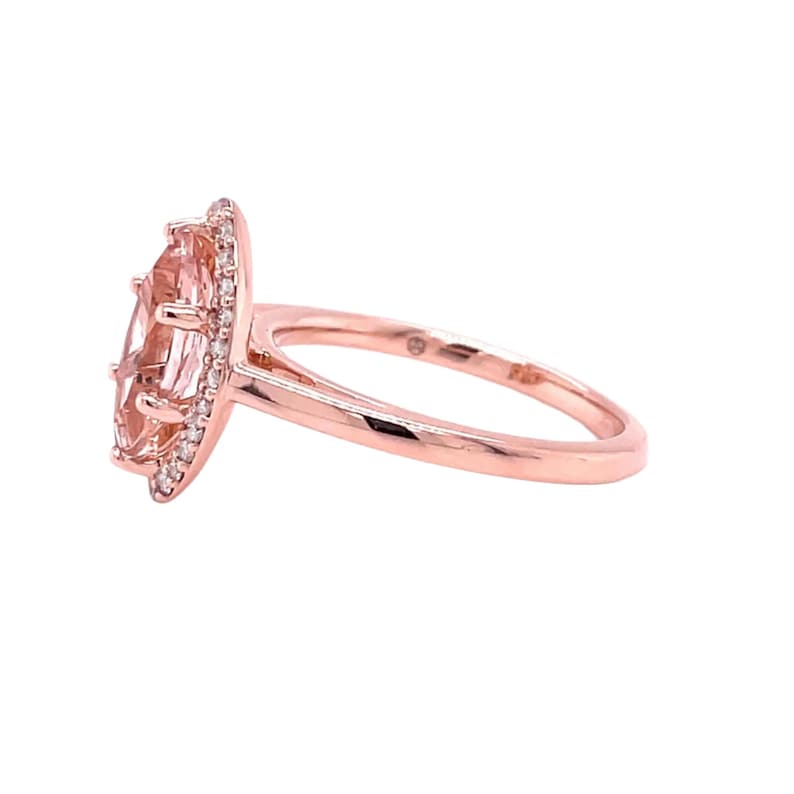 May include: A rose gold ring with a large oval-shaped morganite gemstone surrounded by a halo of smaller diamonds.
