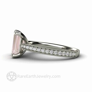 May include: A delicate engagement ring with a pale pink emerald-cut gemstone surrounded by a band of small diamonds.