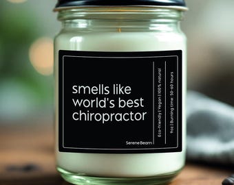 May include: A clear glass candle jar with a black lid and label. The label reads "smells like world's best chiropractor" and "Serene Beam". The label also includes the text "Eco-friendly | Vegan | 100% natural" and "9oz | Burning time: 50-60 hours".