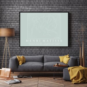 May include: A minimalist line drawing of dancers in a circle, printed on a light blue background. The artwork is framed in black and titled "HENRI MATISSE" with the text "CIRCLE OF DANCERS - 1910 SALON D'AUTOMNE GRAND PALAIS DES CHAMPS-ELYSEES, PARIS" below the image.