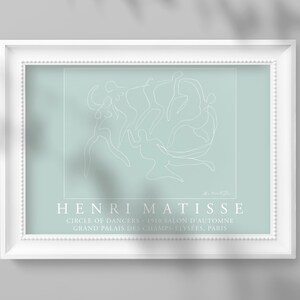 May include: A white line drawing of dancers in a circle on a light blue background. The artwork is framed in white and has the text "HENRI MATISSE" and "CIRCLE OF DANCERS - 1910 SALON D'AUTOMNE GRAND PALAIS DES CHAMPS-ELYSEES, PARIS" below the drawing.