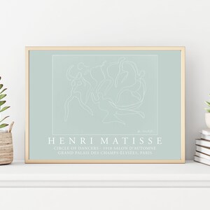 May include: A framed print of a line drawing of dancers in a circle, with the text "HENRI MATISSE" and "CIRCLE OF DANCERS 1910 SALON D'AUTOMNE GRAND PALAIS DES CHAMPS-ELYS&Eacute;ES, PARIS" below the image.