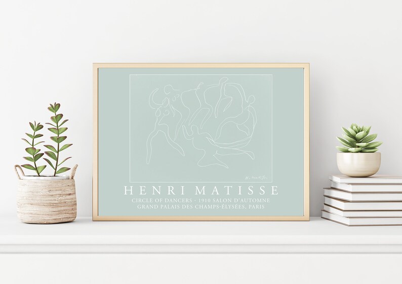 May include: A framed print of a line drawing of dancers in a circle, with the text "HENRI MATISSE" and "CIRCLE OF DANCERS 1910 SALON D'AUTOMNE GRAND PALAIS DES CHAMPS-ELYS&Eacute;ES, PARIS" below the image.