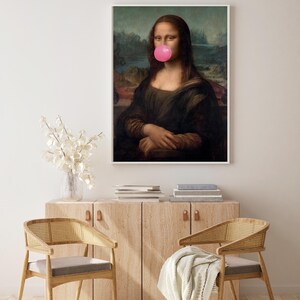 May include: A framed print of the Mona Lisa painting with a pink bubble gum in her mouth.