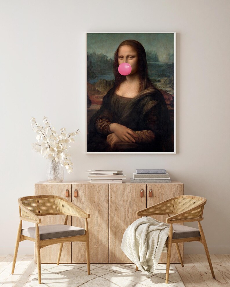 May include: A framed print of the Mona Lisa painting with a pink bubble gum in her mouth.