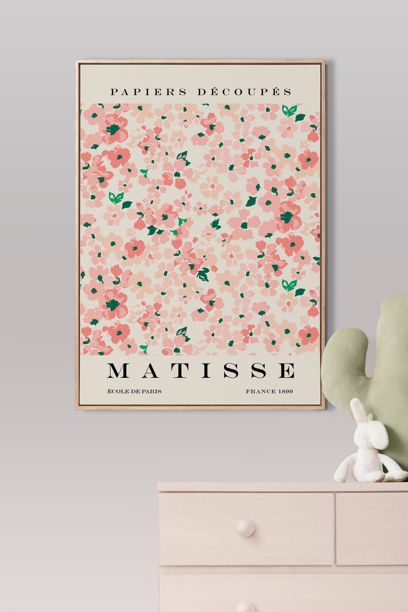 May include: A framed print of a floral design with pink flowers and green leaves. The print is titled "PAPIERS DECOUPES" and features the name "MATISSE" with the text "ECOLE DE PARIS" and "FRANCE 1890".