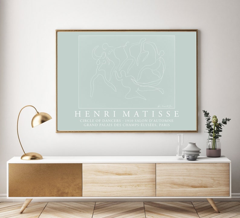 May include: A light blue poster with a white line drawing of dancers in a circle. The text "HENRI MATISSE" is below the drawing, followed by "CIRCLE OF DANCERS - 1910 SALON D'AUTOMNE GRAND PALAIS DES CHAMPS-ELYS&Eacute;ES, PARIS".