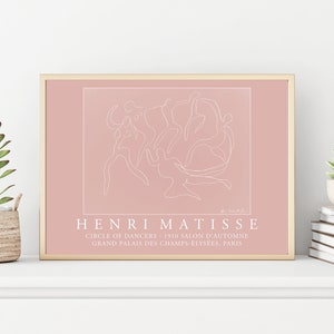 May include: A pink framed print of a line drawing of dancers by Henri Matisse. The print includes the title "Circle of Dancers" and the text "1910 Salon d'Automne Grand Palais des Champs-Elysees, Paris".