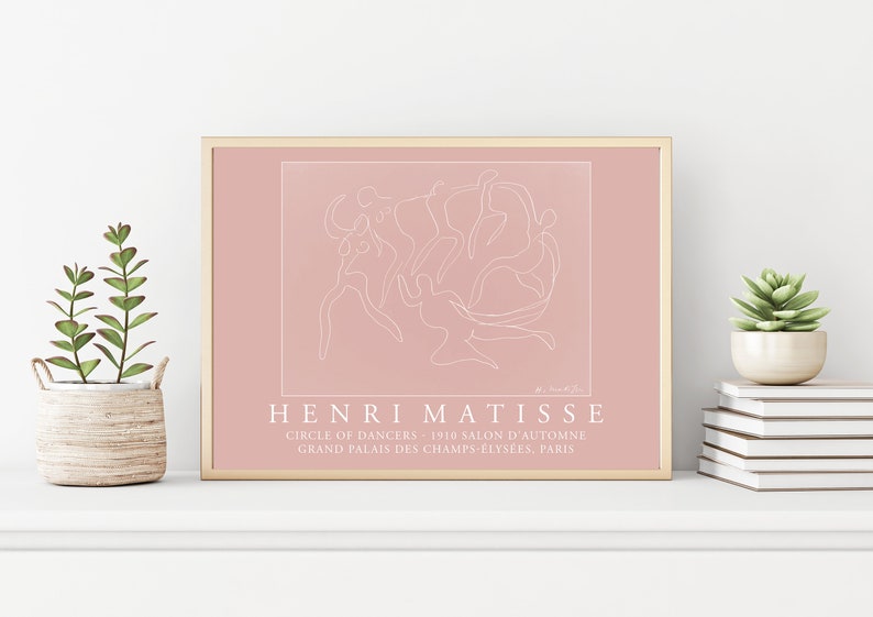 May include: A pink framed print of a line drawing of dancers by Henri Matisse. The print includes the title "Circle of Dancers" and the text "1910 Salon d'Automne Grand Palais des Champs-Elysees, Paris".