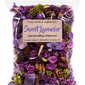 May include: A clear plastic bag filled with dried purple and green botanical elements, including small pinecones and flower buds. A label reads: Shoots, Roots & Leather Boots, Sweet Lavender, Handcrafted Potpourri, Proudly Made in Robertson County, TN.