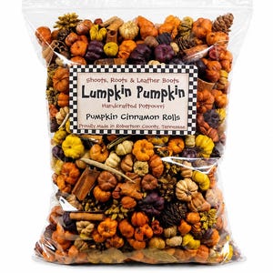 May include: A clear plastic bag filled with decorative potpourri featuring miniature orange, yellow, and purple pumpkins, cinnamon sticks, and pinecones. The label reads: Shoots, Roots & Leather Boots, Lumpkin Pumpkin, Handcrafted Potpourri, Pumpkin Cinnamon Rolls, Proudly Made in Robertson County, Tennessee.