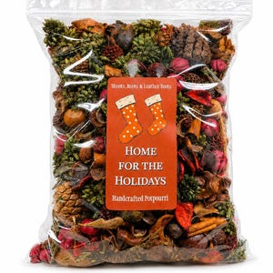 May include: A clear plastic bag filled with dried potpourri containing pinecones, red berries, green foliage, and cinnamon sticks. The center label features two orange polka-dot stockings and the text: Shoots, Roots & Leather Boots, HOME FOR THE HOLIDAYS, Handcrafted Potpourri.